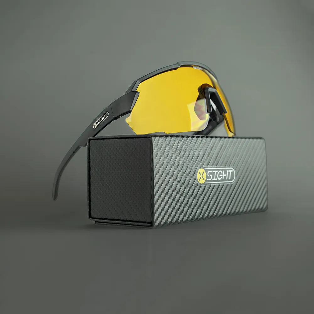 The Fulcrum Shooting Glasses by X Sight Sport are showcased in this product photo. The glasses are displayed on top of a sleek and compact smart fold-up carbon fiber effect case, which provides secure storage and portability. The lenses of the Fulcrum glasses feature a vibrant XTRM yellow tint, designed to enhance target contrast and visibility. These glasses are a fixed lens model, with adjustable metal core temples and metal core nose pads for a customized fit and added durability. Experience comfort, style, and functionality with the Fulcrum Shooting Glasses.